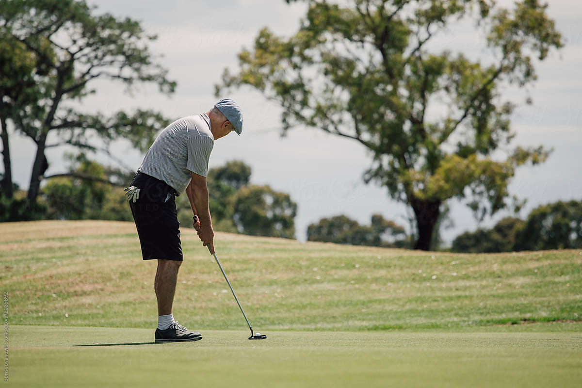 Older man golfing on course
